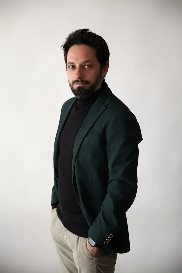 Antonino Polimeni in piedi, giacca verde, ritratto informale